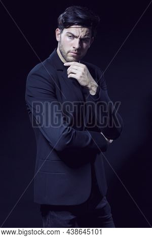 Portrait Of Handsome Caucasian Brunet Businessman Wearing Black Suit Posing With Folded Hands And To