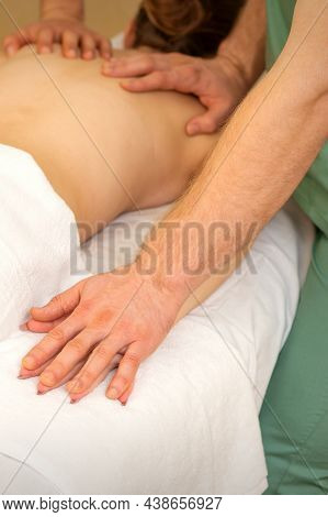 Back And Hands Double Massage With Four Hands Of Two Professional Massagers For A Young Caucasian Wo