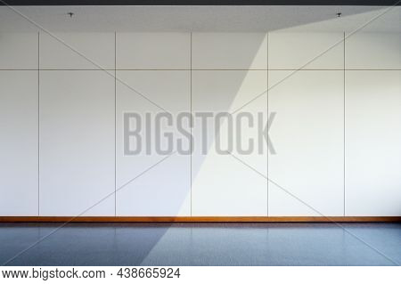 Empty Room Interior With Black Floo, White Wall Background And Fire Sprinkler On Ceiling. Sunlight I