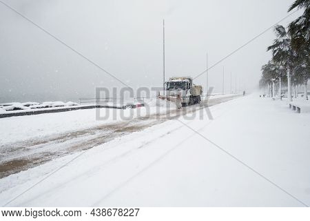 Truck Cleaning  Winter Road Covered With Snow At The Sea Side Park