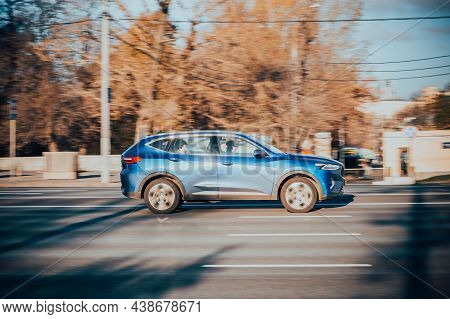 Moscow, Russia - October 2021: Blue Haval F7 Suv Is Driving Along The Street With An Autumn Urban Ba
