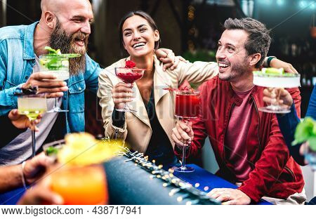 Hipster Friends Toasting Multicolored Fancy Drinks At Fashion Bar - Trendy People Having Fun Togethe