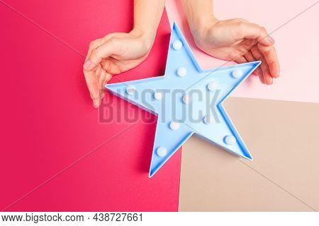 Female  Manicure. Beautiful Young Woman's Hands Holdinh A Star On Color Pink  Background - Image