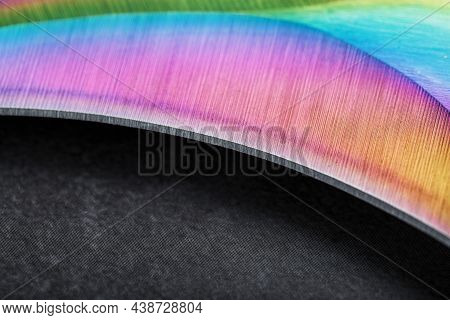 The Sharp Blade Of The Kerambit Knife Made Of Steel Is Multicolored In Close-up On A Dark Background