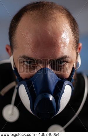 Portrait Of Runner Man Wearing Mask Looking Into Camera While Working At Body Endurance In Modern Pr