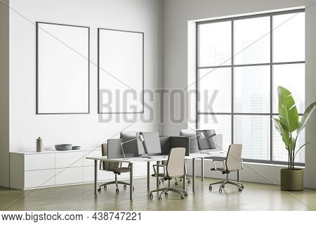 Two Empty Canvases On Wall In White And Olive Office With Work Station, Concrete Flooring And Floor 