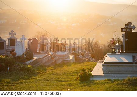 Headstones and grave sites in magic sunset at a cemtery