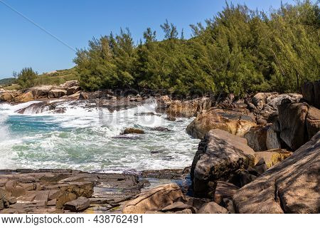 Cliff Rocks With Vegetation And Waves