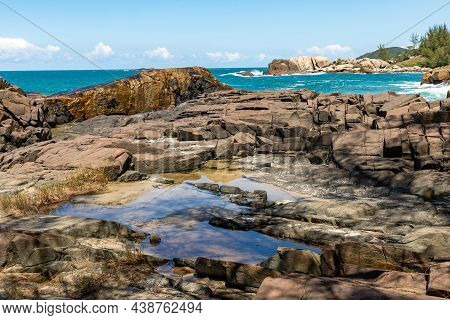 Rocks, Waves And Sand On The Beach