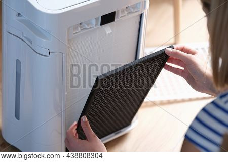 A Woman Removes A Filter From An Air-purifying System, Close-up. Dust Collector Replacement And Clea