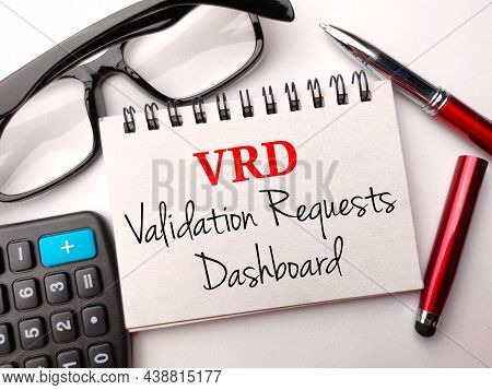 Glasses,calculator,pen And Notebook With Text Vrd Validation Requests Dashboard On A White Backgroun