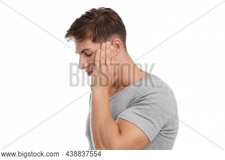 Unhappy Young Caucasian Handsome Guy Presses His Hand To Temple And Suffers From Headache