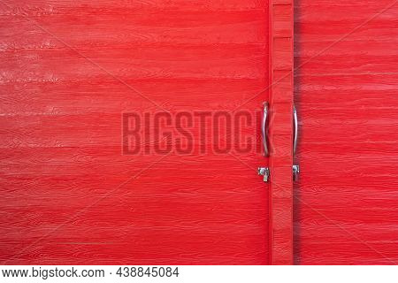 Metal Lock And Door Handle On The Red Wooden Door. Abstract Red Wood Planks Background Wall Texture.