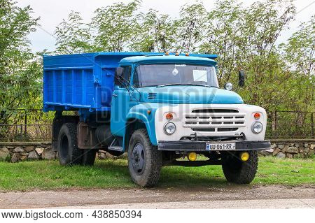 Kakheti, Georgia - October 9, 2021: Old Soviet Dump Truck Zil-mmz-554 In A City Street.