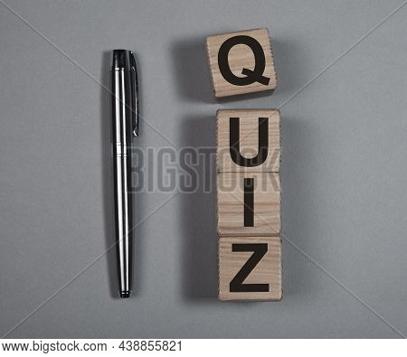 Quiz Or Quizz Concept. Word On Wood Cubes On Gray Background.