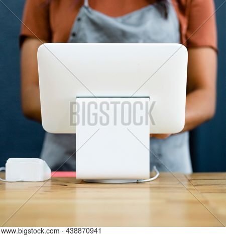A small business owner at a cash register