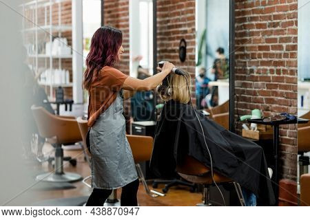 Hairstylist giving a haircut to a customer at a beauty salon