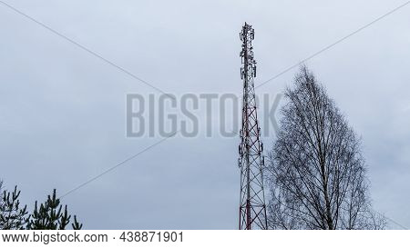 Tower With Mobile Operator Antennas On The Dramatic Sky Background. Tower Hosted Equipment Cellula. 
