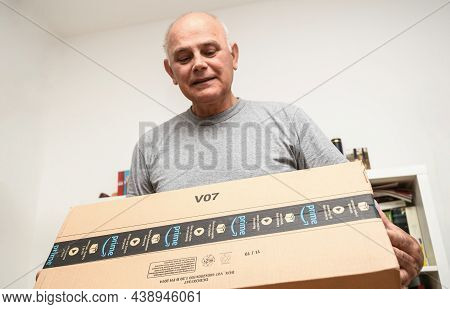 Paris, France - Oct 10, 2019: Happy Senior Man Looking At The Integrity Of New Amazon Prime Parcel L