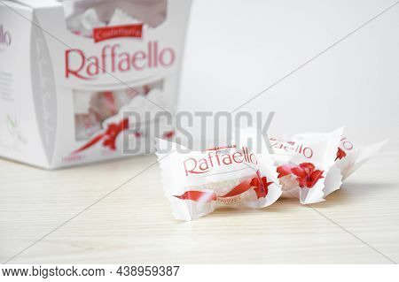Raffaello Sweets On A Light Wooden Table And White Background.