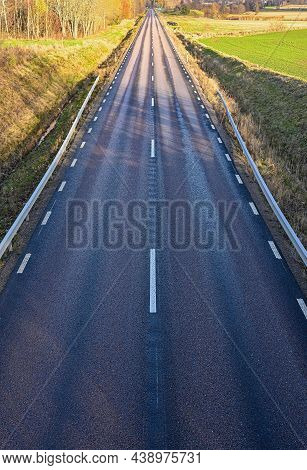 Straight Highroad With Wet And Dry Tarmac