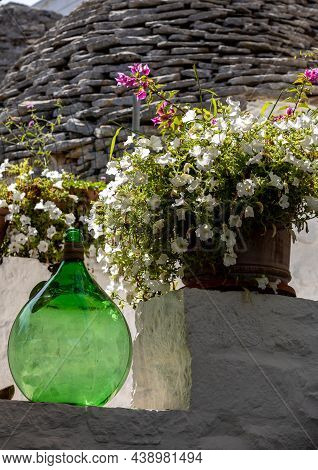 Demijohn Wine Bottle At Cafe In Trulli Village In Alberobello, Italy.