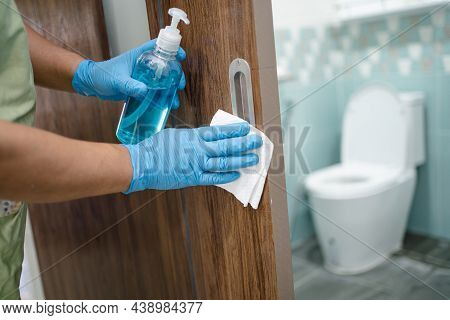 Cleaning Door Toliet Handle At Toilet With Alcohol And Tissue At Office And Home For Protect Covid 1
