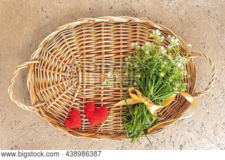 Wicker Tray With Wildflowers Tied With Ribbon Red Knitted Hearts And Template For Design On Beige Pl