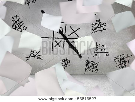 White paper in front of grey wall with ticktacktoe