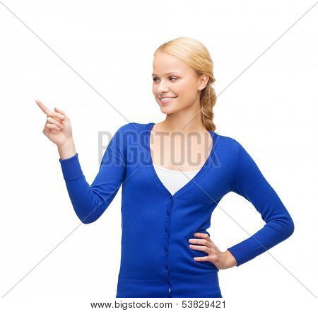 advertisement concept - attractive young woman in casual clothes pointing her finger