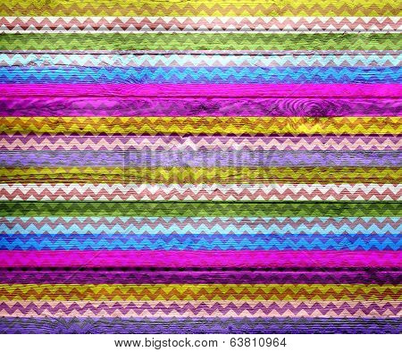 Colorful chevron pattern on wood texture background
