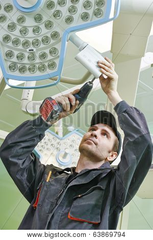 Carpenter joiner with screwdriver mounting equipment at surgery room in clinic