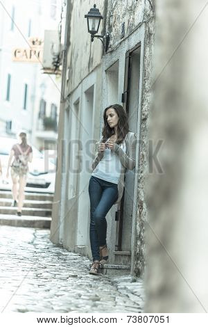 Beautiful Girl Waiting In A Historic Street