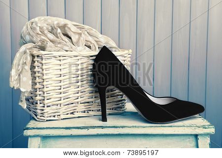 Black women shoes and scarf on wooden background
