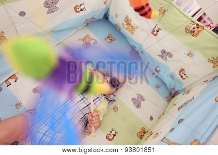 Playful Kid In His Bed With Sunglasses