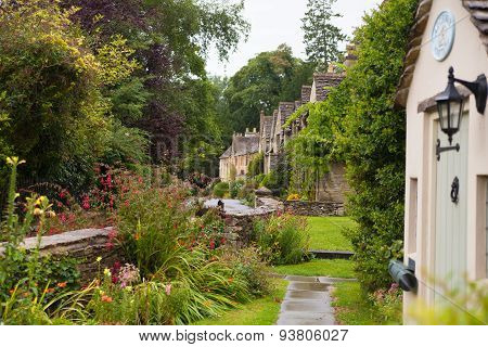 CHIPPENHAM, UK - AUGUST 9, 2014: Castle Combe, unique old English village. Old house and park