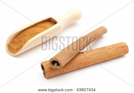 Powdery And Stack Of Cinnamon Sticks On White Background