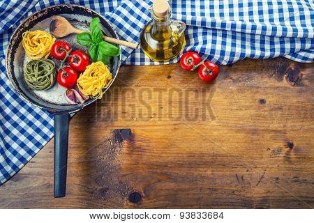 Italian and Mediterranean food ingredients on wooden background.Cherry tomatoes pasta