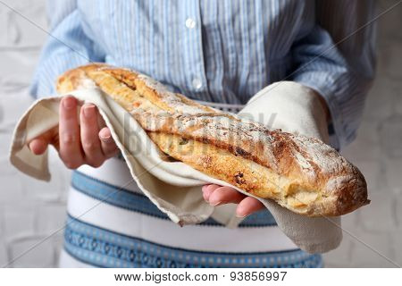Woman holding tasty fresh bread, close up