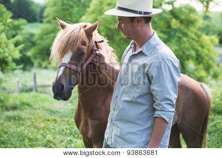 Horse and man in panama hat