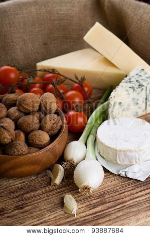 Two Heads Of Spring Onion And Various Cheeses