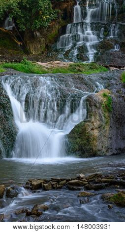 The largest handmade waterfall in Ukraine. Green grass moss and leaves flavor the composition. Place - Chervonohorod or Chervone - part of the municipal district of Nyrkiv.