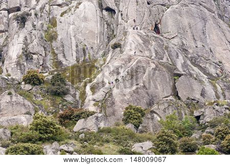 Climbers at Pico de la Miel (Honey Peak), in Sierra de la Cabrera, Guadarrama Mountains, Madrid, Spain