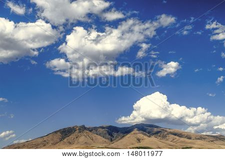 Mount Ara ler in sunny day against the blue sky covered by clouds