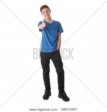 Cute teenager boy in blue T-shirt standing and poinitng forward over white isolated background full body