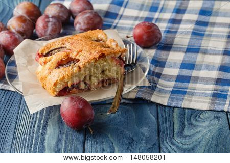 slice of bavarian plumcake on blue background