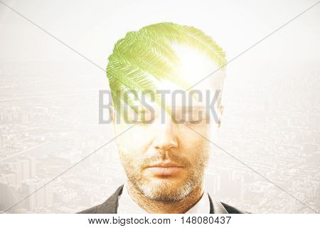 Portrait of handsome young businessman thinking about holidays on city background. Overworked concept. Double exposure