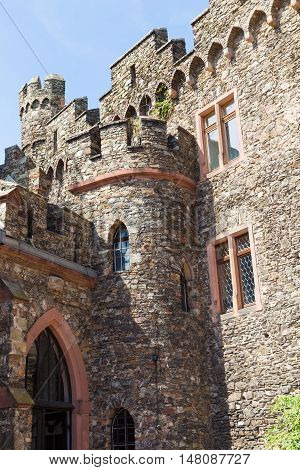 Reichenstein Castle Rhine Valley Germany - UNESCO World Heritage Site - courtyard : stone wall with windows tower against blue sky