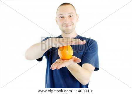 man holding orange in hand