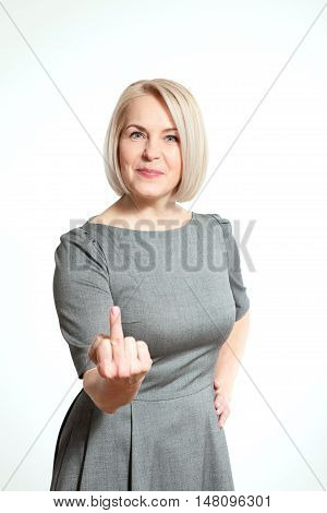 Woman shows sign of fuck off. Sexy middle aged woman showing middle finger in face with a grimace closeup. Professional makeup
